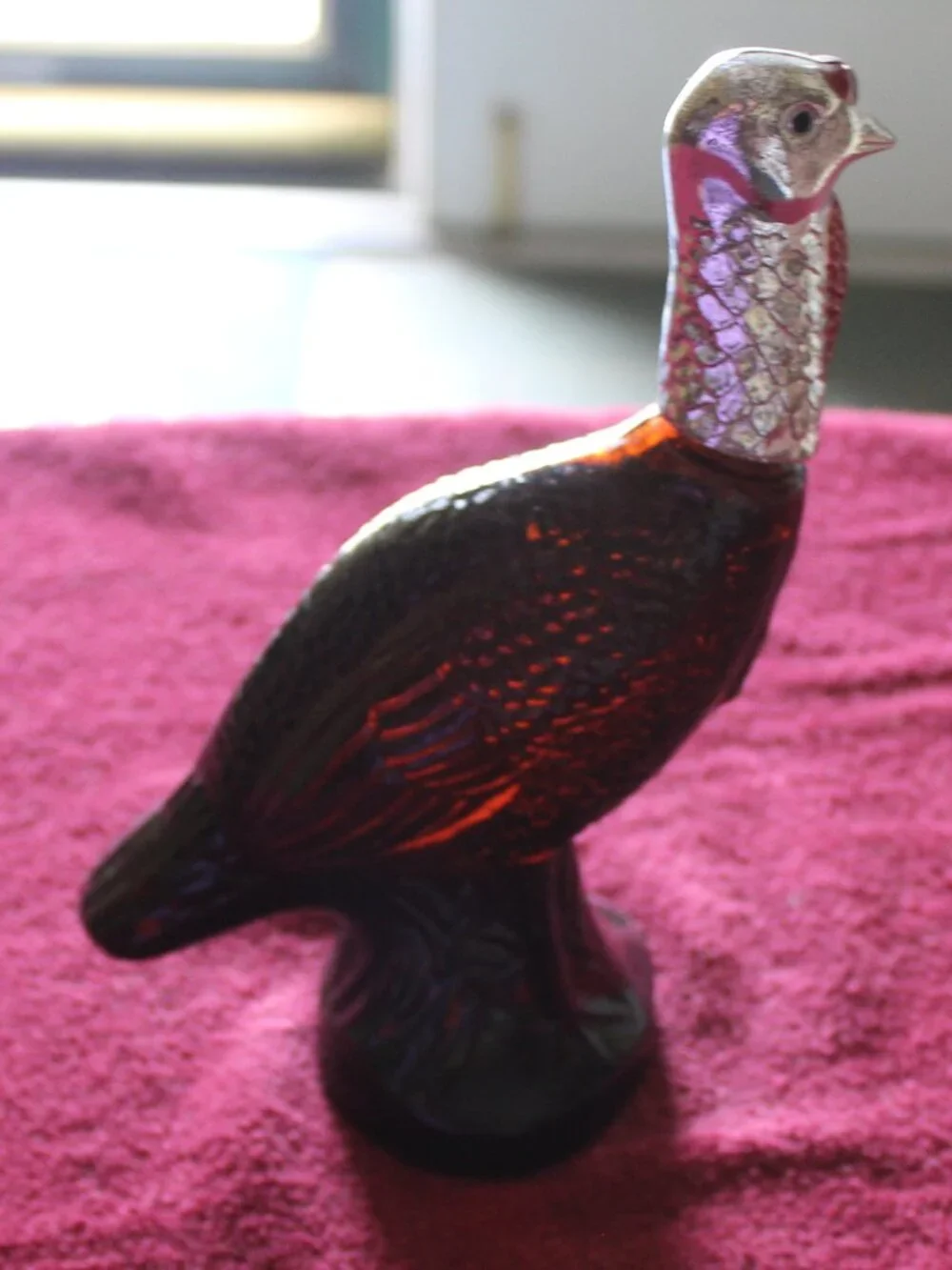 Vintage Avon Wild Turkey bottle, featuring brown glass and a silver-colored head